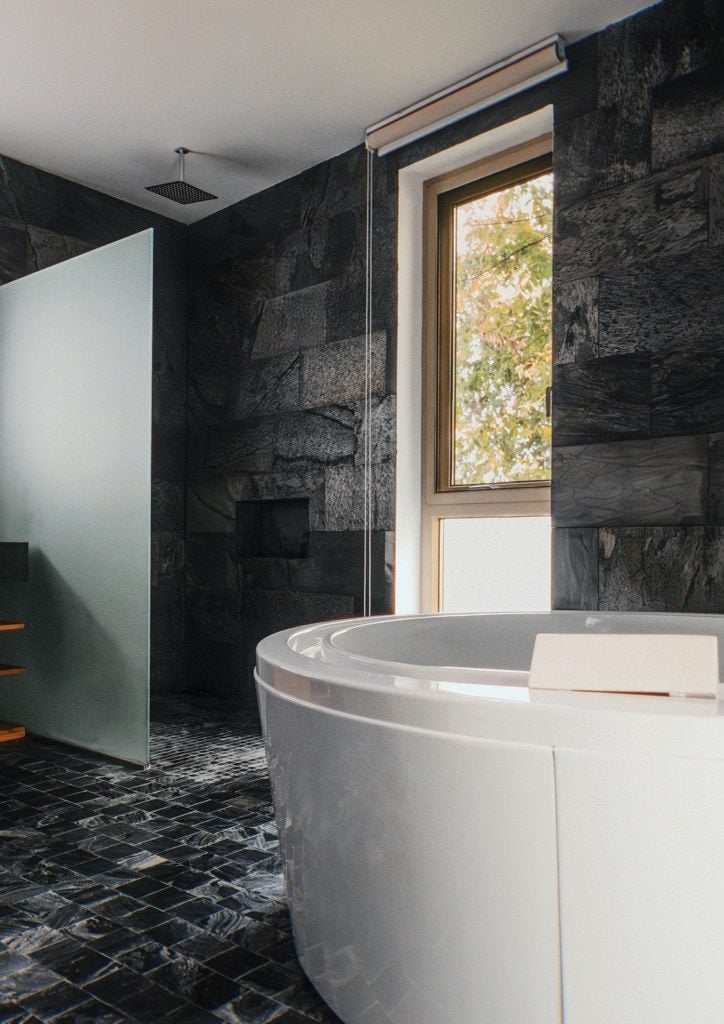 Spa bathroom in dark stone with freestanding tub