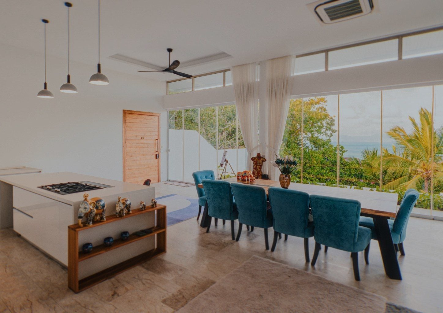 Open-plan kitchen and dining room with floor-to-ceiling glass